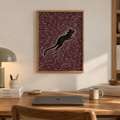 A sleek black cat stretches gracefully through a hypnotic swirl of maroon and cream lines — artwork print detail