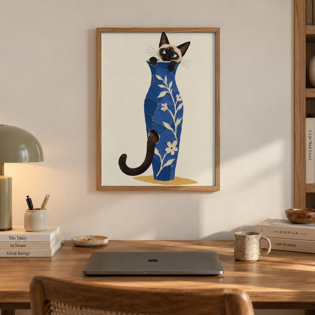 A curious Siamese cat peeks out from a collage-style blue floral vase, tail curling around the base — artwork print detail