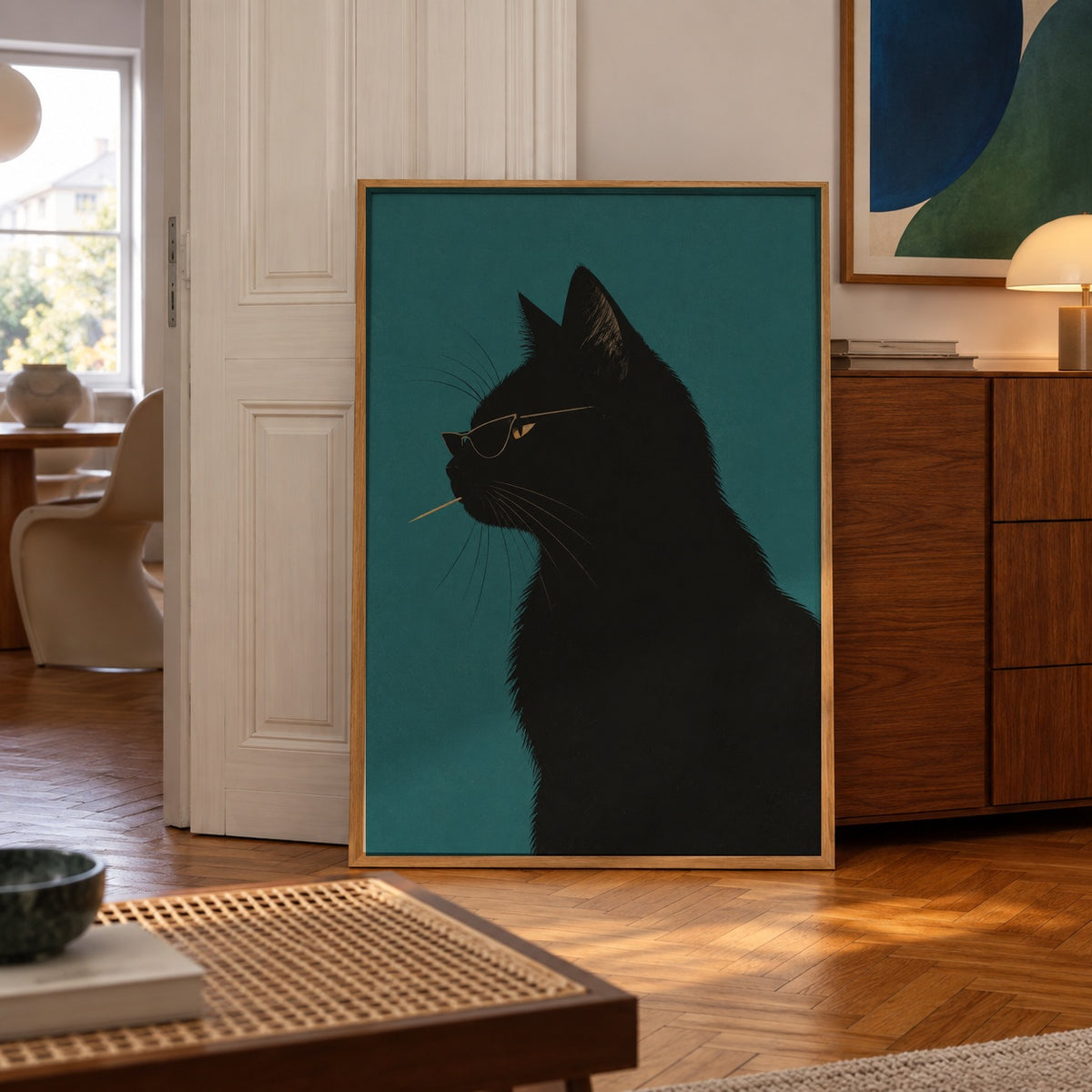 A sleek black cat profile, shades on and toothpick in mouth, poses against a deep teal backdrop — poster displayed in a styled room