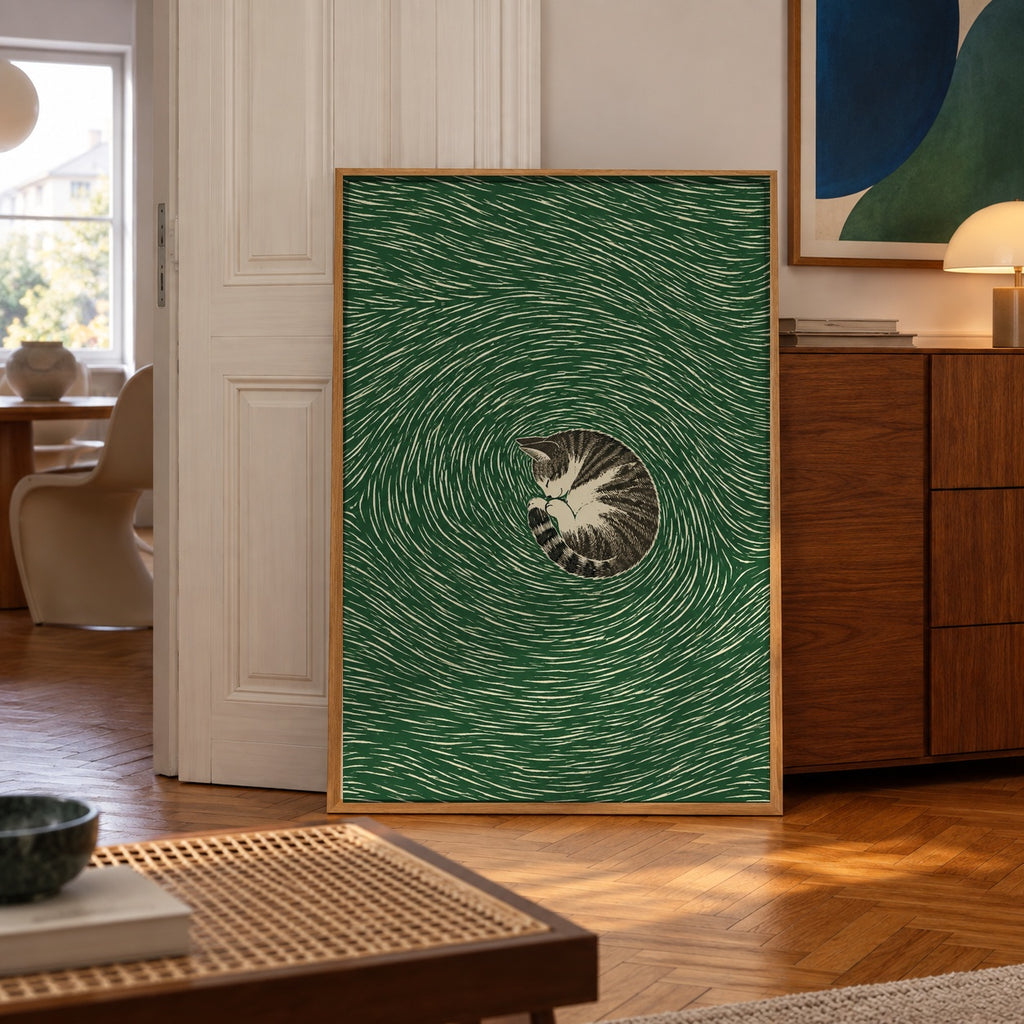 A sleeping tabby cat curls into a tight spiral at the center of swirling emerald linework — poster displayed in a styled room