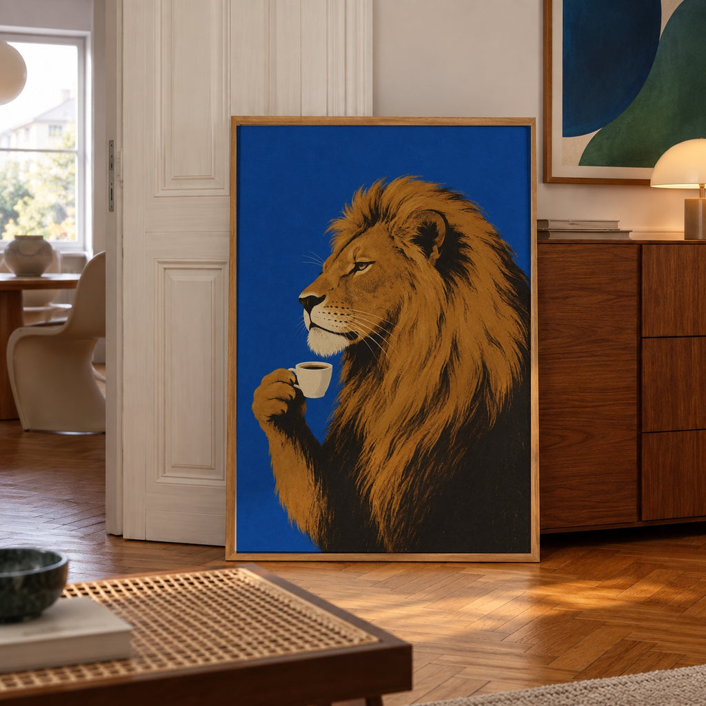 A regal lion pauses for a quiet espresso moment against a bold cobalt blue backdrop — poster displayed in a styled room
