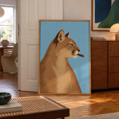 A sly mountain lion strikes a confident pose, cigar in mouth, against a bold sky-blue backdrop — poster displayed in a styled room