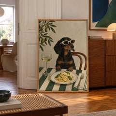 A stylish dachshund dons oversized sunglasses while sitting down to a plate of spaghetti and a glass of wine — poster displayed in a styled room