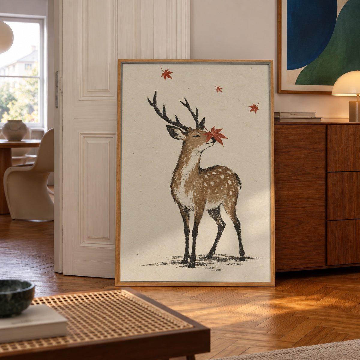 A gentle stag catches a maple leaf on its nose amid a soft autumn breeze — poster in a styled room