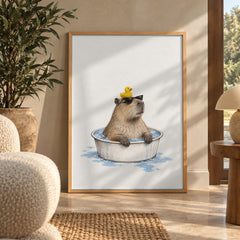 A cool capybara soaks in a tiny tub, sunglasses on and a rubber duck perched on its head — wall art poster display
